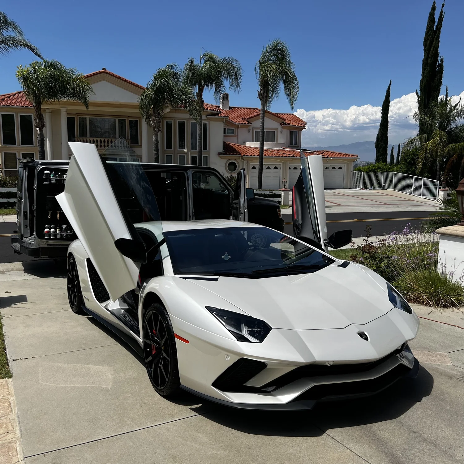 White Lamborghini receiving mobile detailing service at an Orange County home