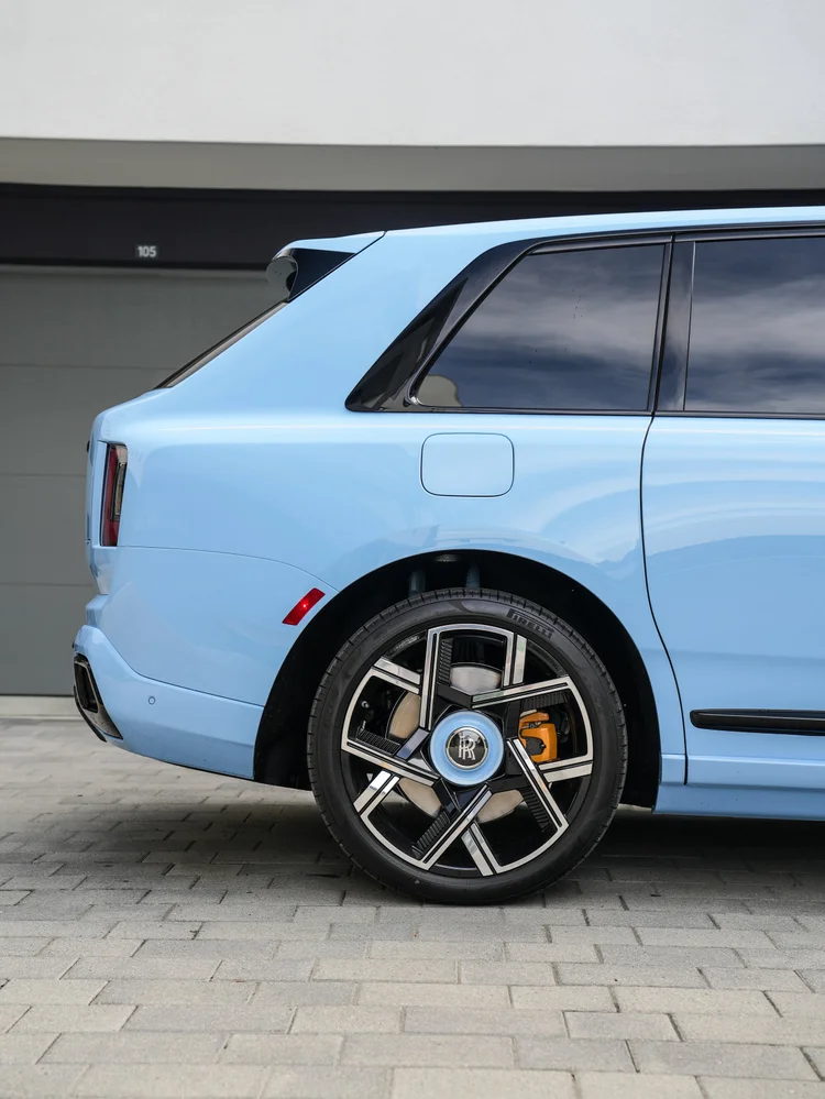 Powder Blue Cullinan rear quarter, fuel flap and two-tone rear wheel beneath dark side glass