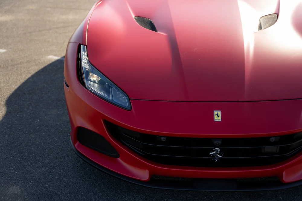 Red Ferrari Portofino hood ridges, mesh vents, headlight, yellow badge and black grille from above