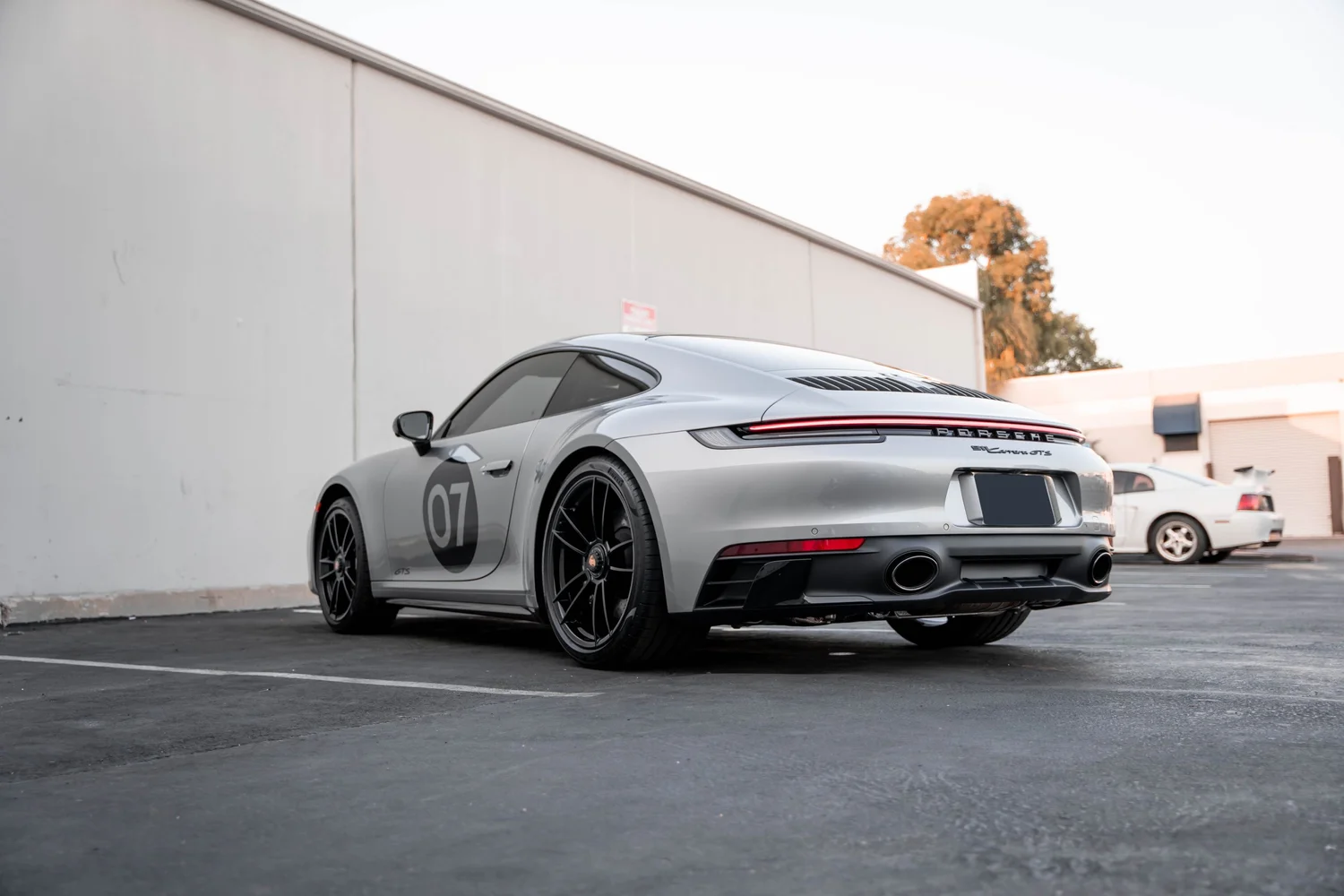 Porsche 911 Carrera GTS (992.1) after Paint Protection Film (PPF), Window Tint, Ceramic Coating and Custom Graphics, rear-right three-quarter view