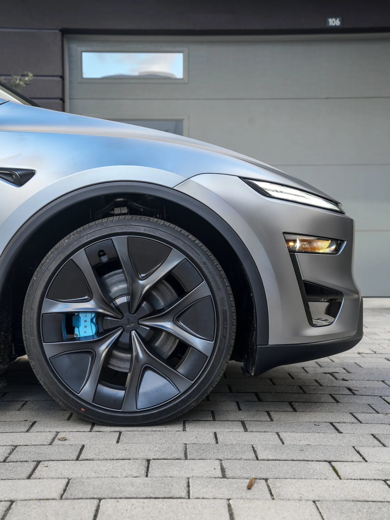 2026 Tesla Model Y Performance front wheel and baby blue brake caliper detail after full XPEL STEALTH PPF and baby blue brake caliper repaint