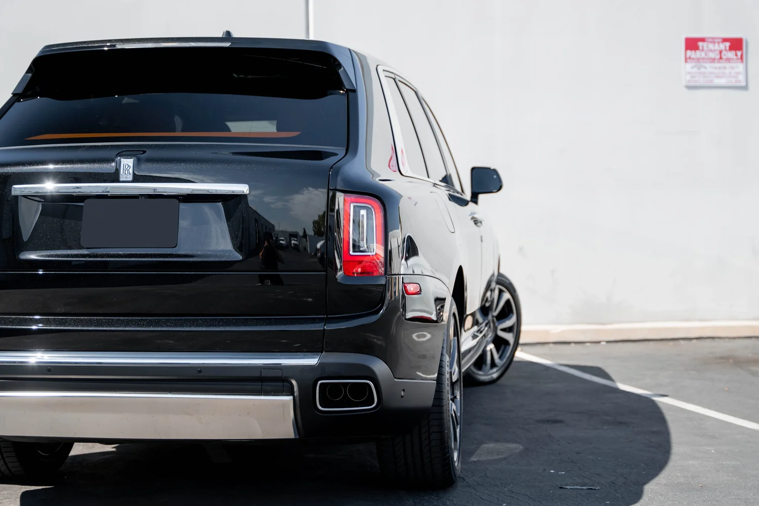 Black Rolls-Royce Cullinan with Chrome Exterior Trim after Paint Protection Film (PPF), Window Tint and Ceramic Coating, tight rear three-quarter view