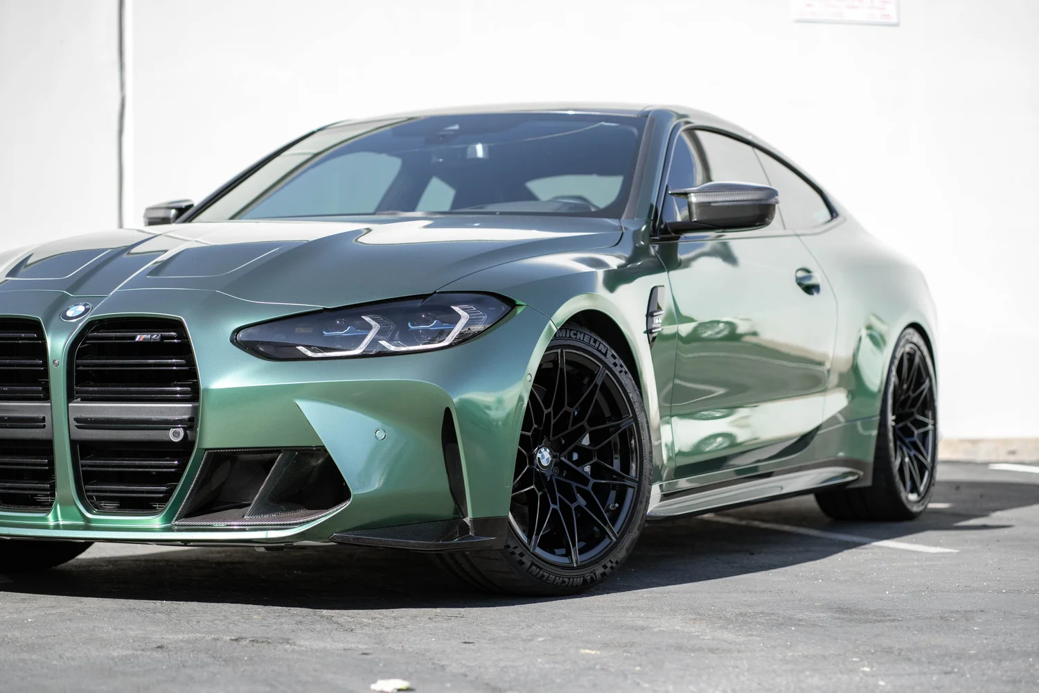 BMW M4 Racing Green after Vinyl Wrap, front wheel and body view