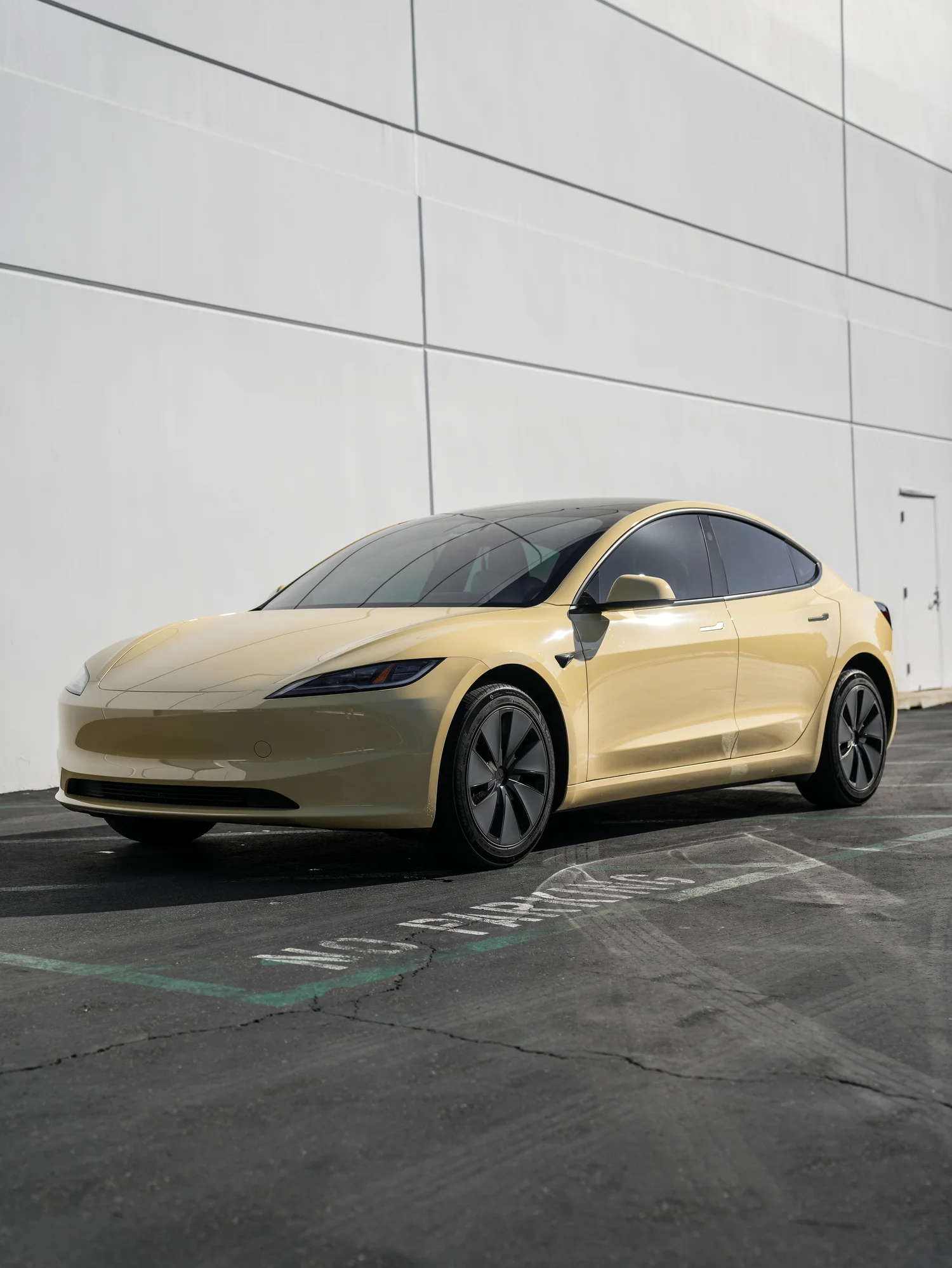 Tesla Model 3 Sunrise Yellow after Vinyl Wrap, front-left three-quarter view