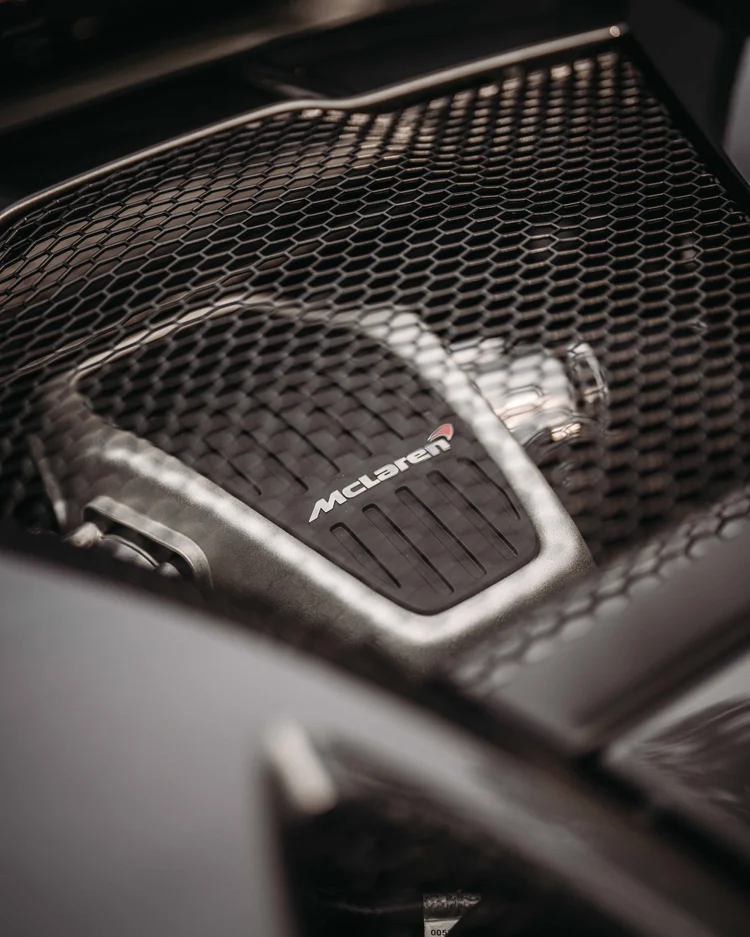 McLaren-marked component visible beneath the rear deck's hexagonal mesh.