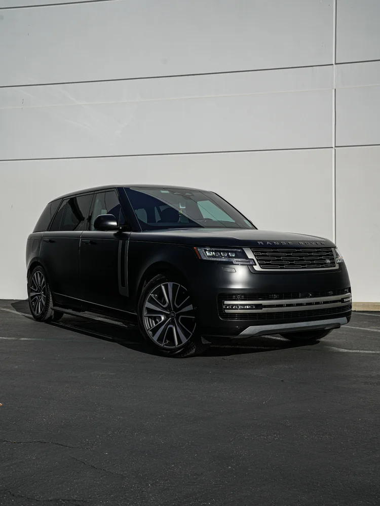 Complete front three-quarter view of the black Range Rover, with silver grille trim, dark glass and two-tone wheels.