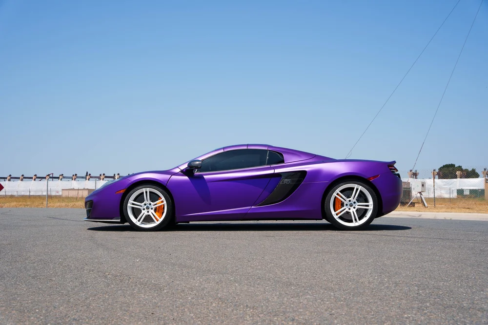 McLaren MP4-12C — full side profile showing the low roofline, white wheels and deep air intake