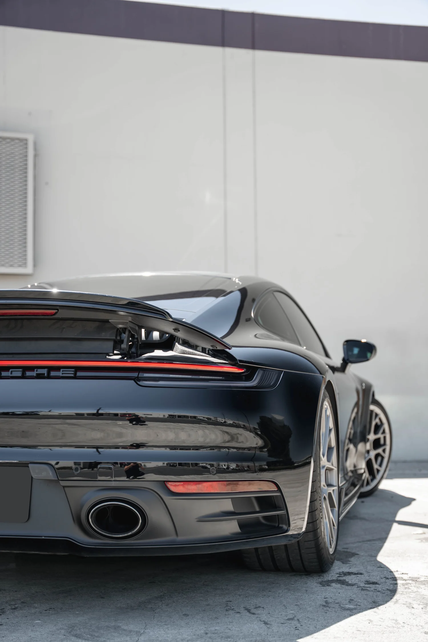 Porsche 911 Carrera S (992.1) after Paint Protection Film (PPF) and Ceramic Coating, rear-quarter and wheel view