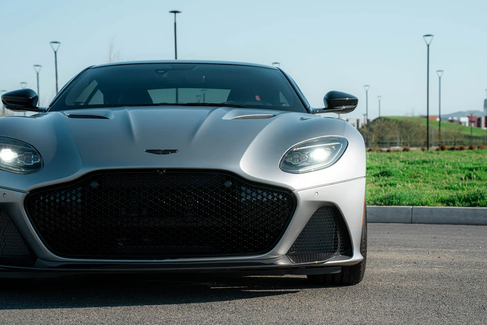 Closer straight front view of the matte-finish DBS with headlights and a large dark grille