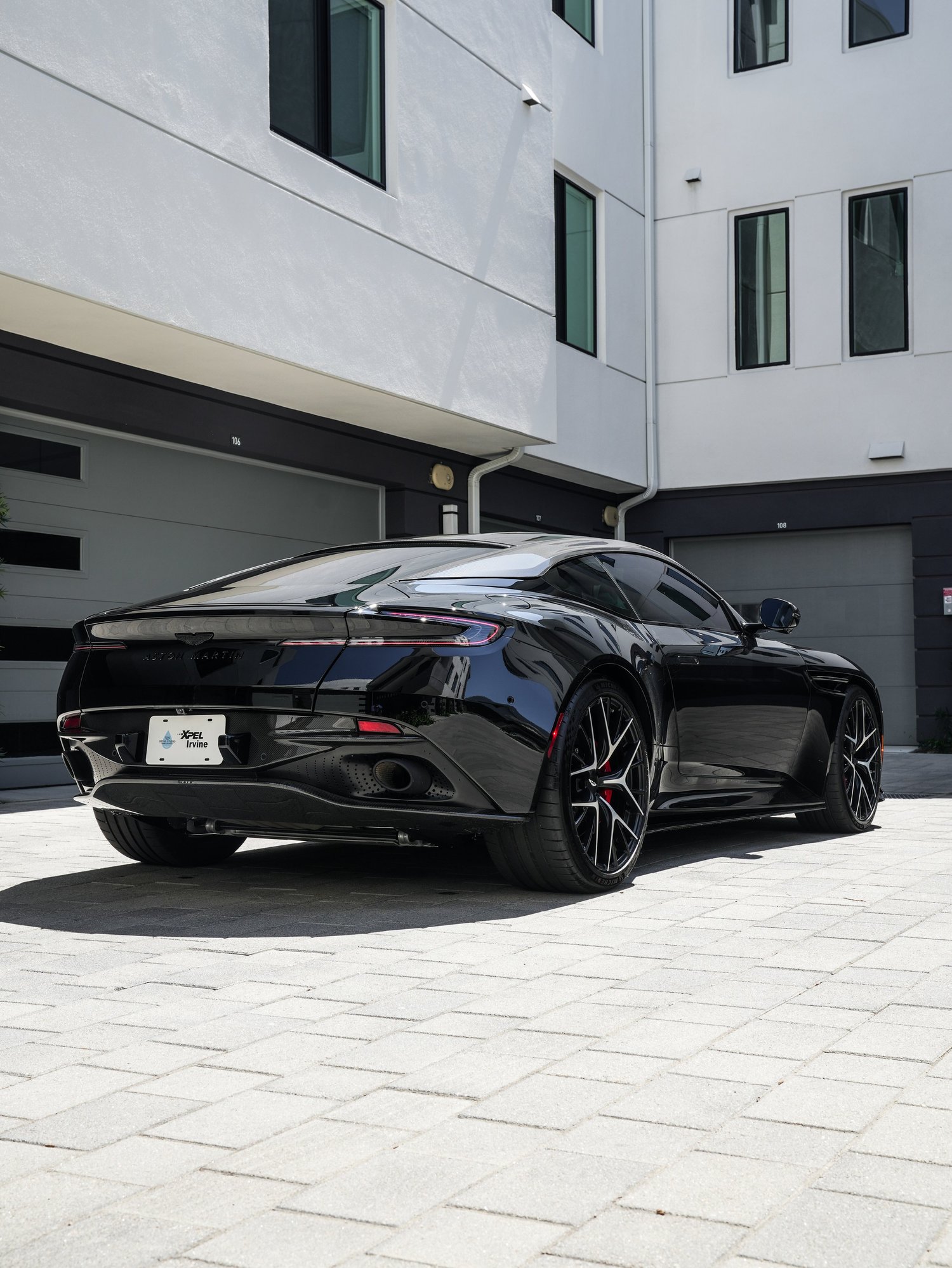Aston Martin DB12 rear three-quarter view from the driver side after full exterior PPF, window tint and ceramic coating