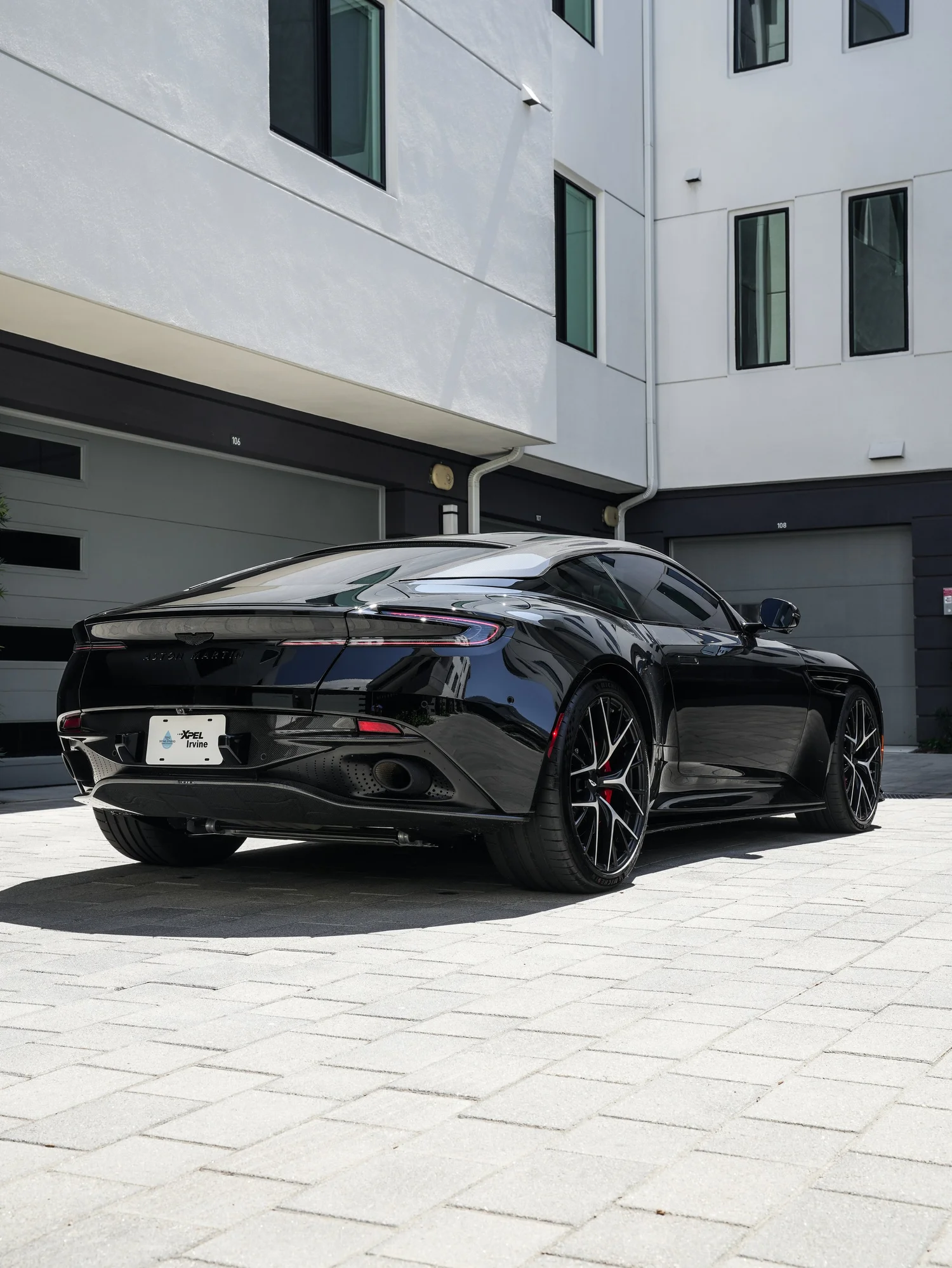 Aston Martin DB12 rear three-quarter view from the driver side after full exterior PPF, window tint and ceramic coating