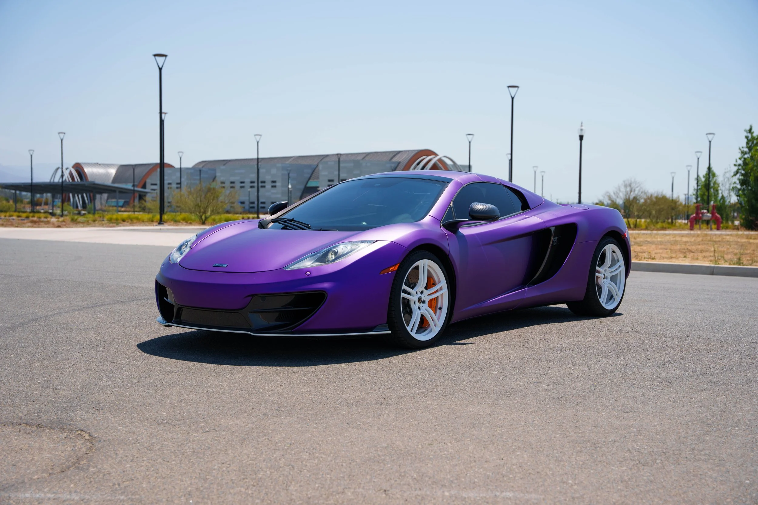 McLaren MP4-12C — complete front three-quarter view showing both white wheels and the side air intake