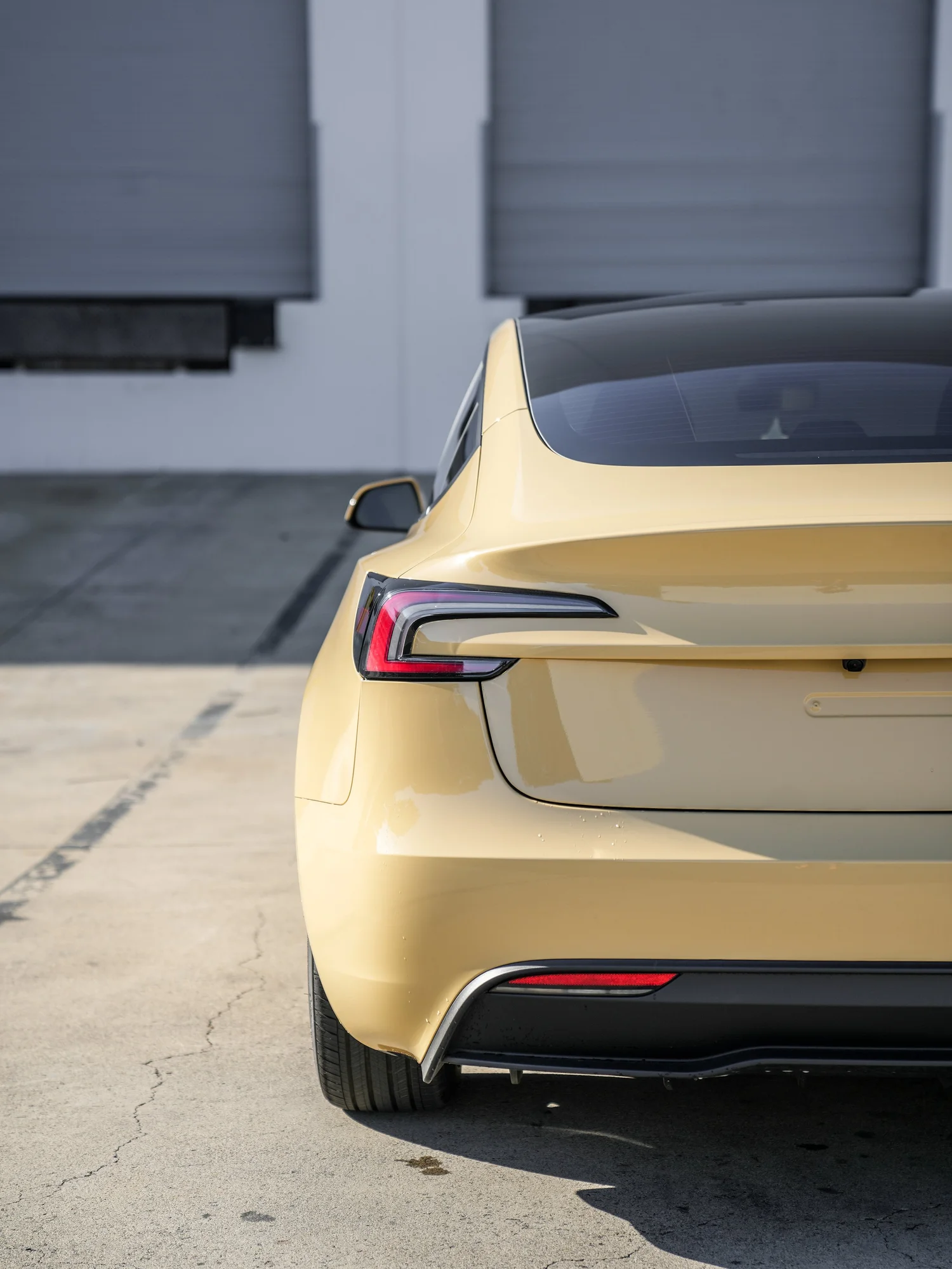 Tesla Model 3 Sunrise Yellow after Vinyl Wrap, rear body and taillight view