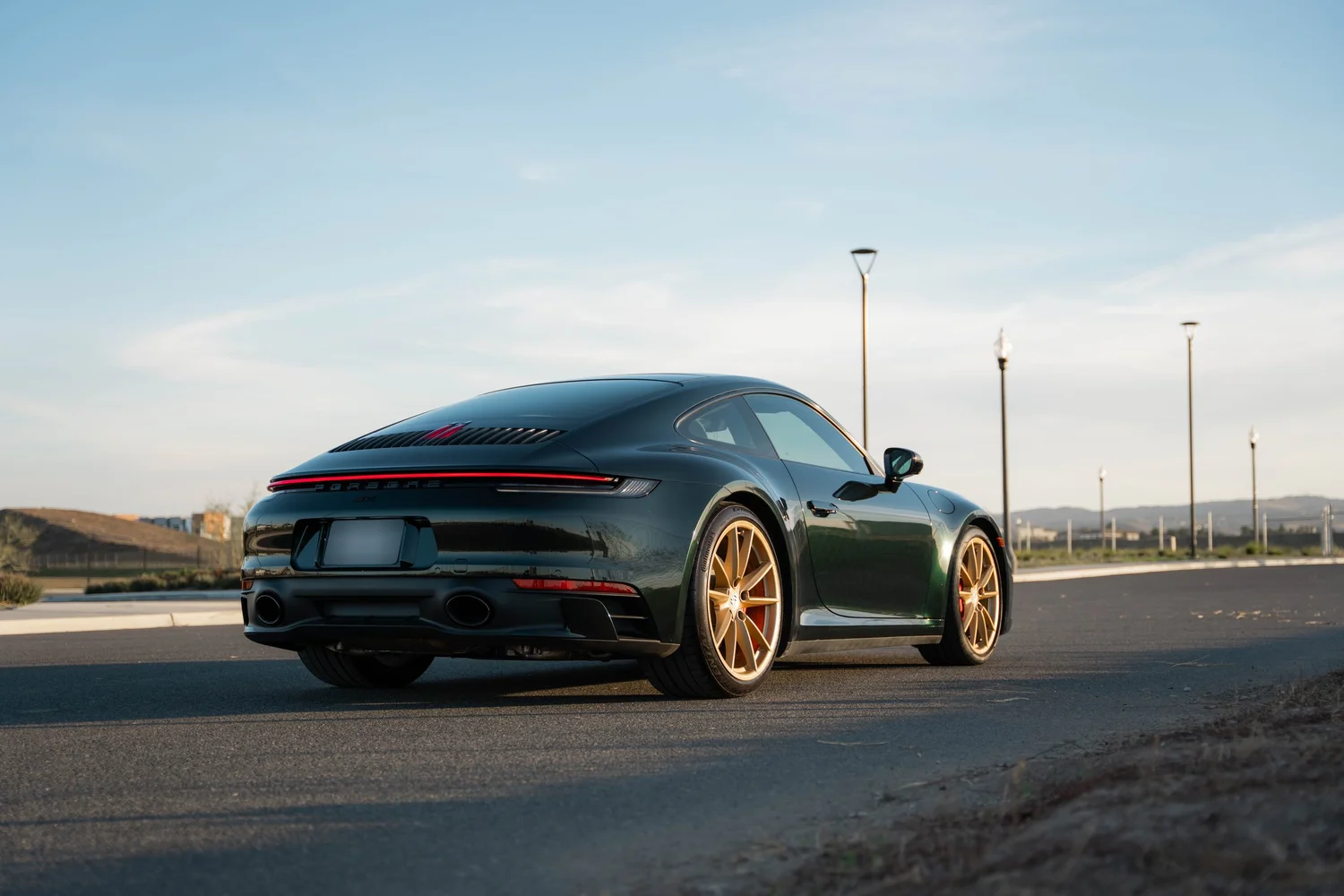 Porsche 911 Carrera Wrapped in British Green after Vinyl Wrap, rear-right three-quarter view