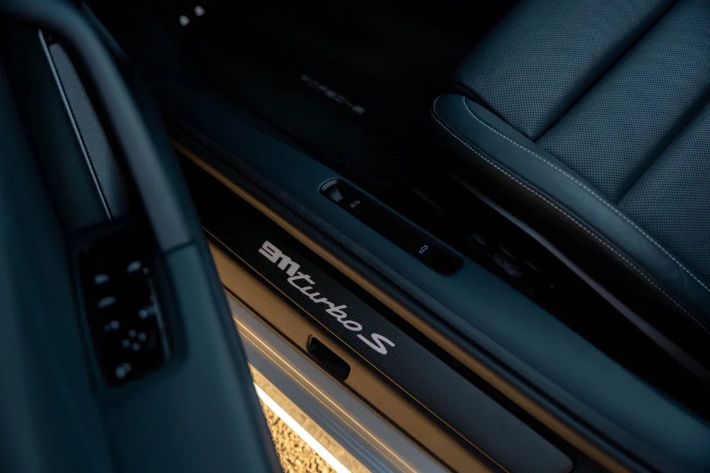 Chalk Porsche 911 Turbo S, Turbo S door-sill badge beside the black seat