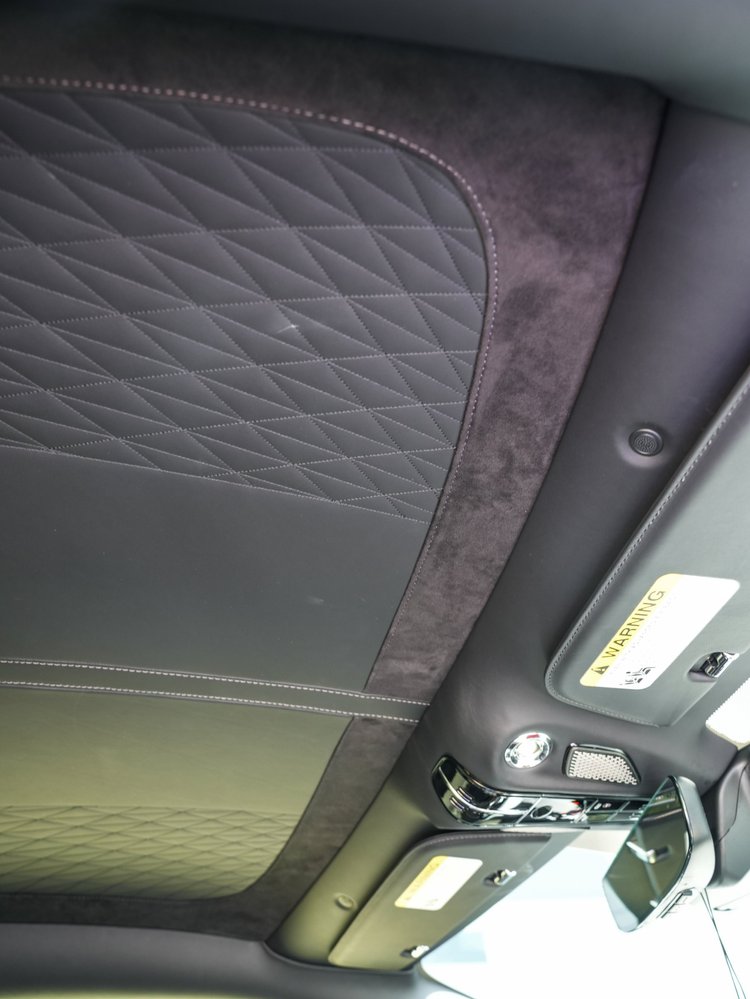 Quilted DB12 headliner with overhead controls, sun visors and rearview mirror.