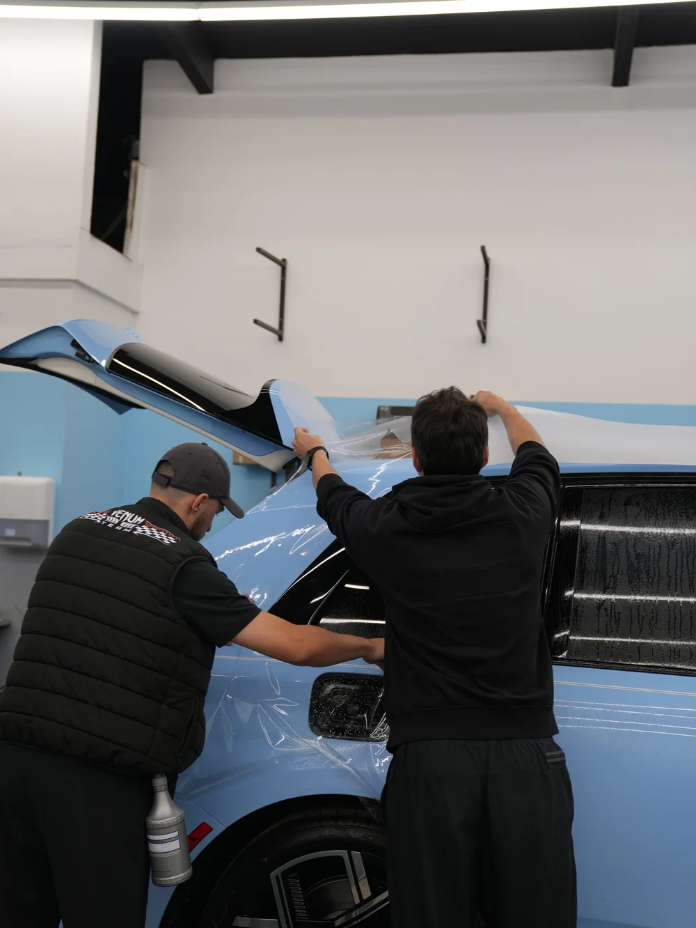 Technicians installing full-body PPF on Rolls-Royce Cullinan Series II