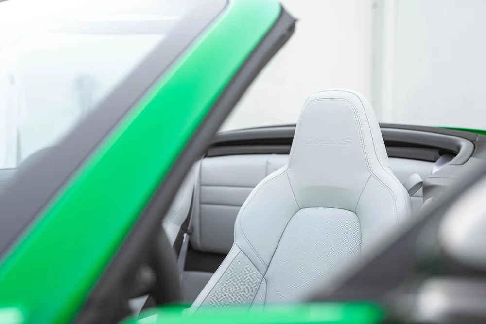 Signal Green Porsche 911 Turbo S, light front seat with Turbo S headrest embroidery and green windshield frame