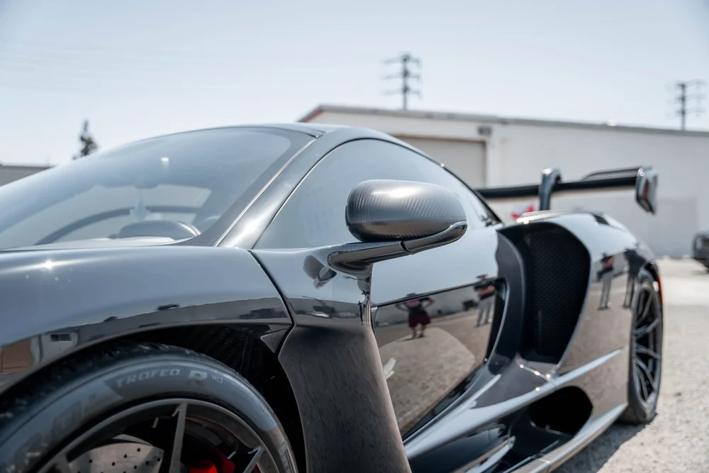 McLaren Senna side mirror, sculpted door and deep side air intake in landscape close view