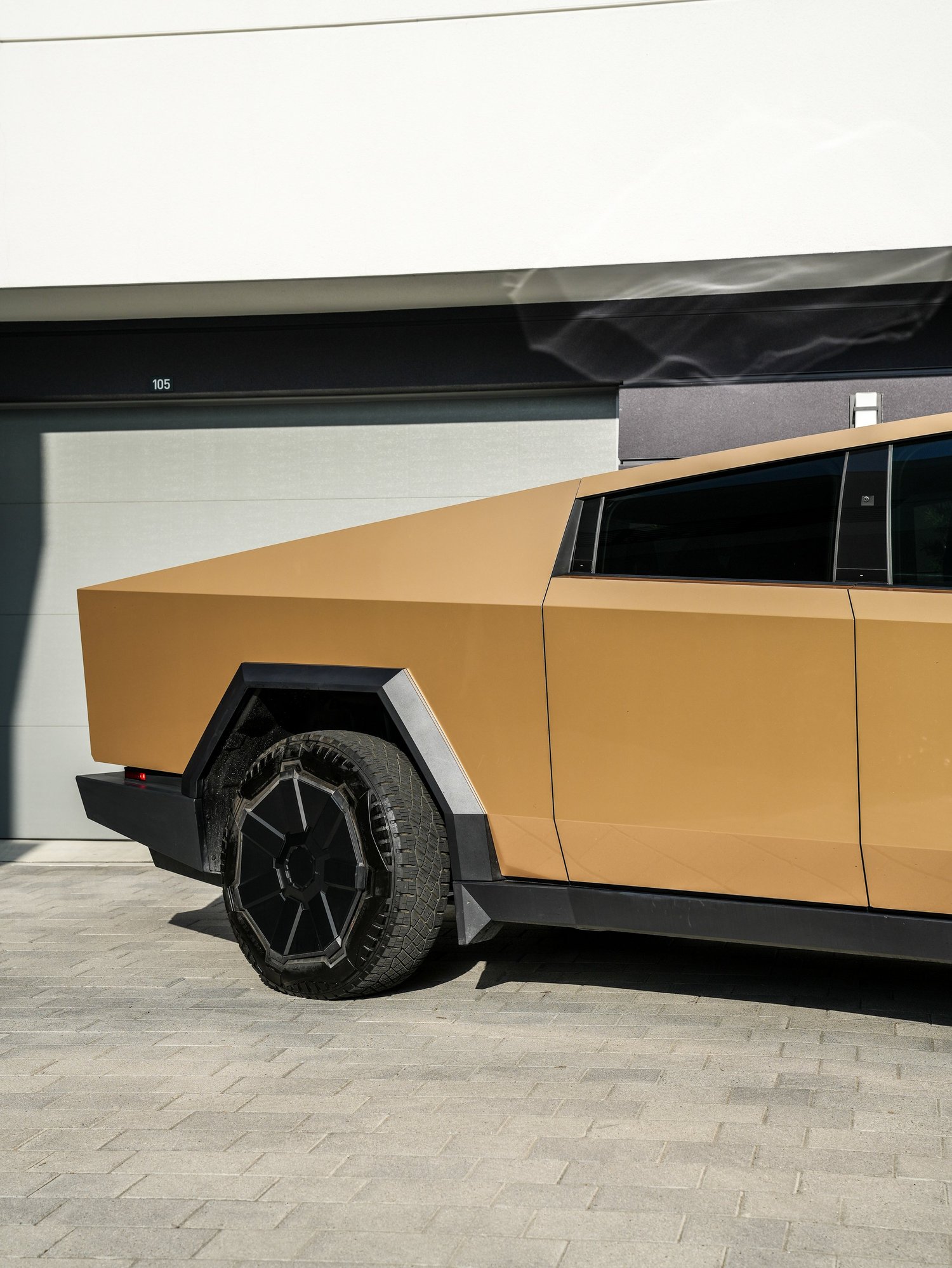 Tesla Cybertruck Milan Gold after Paint Protection Film (PPF) and Window Tint, rear-quarter and wheel view