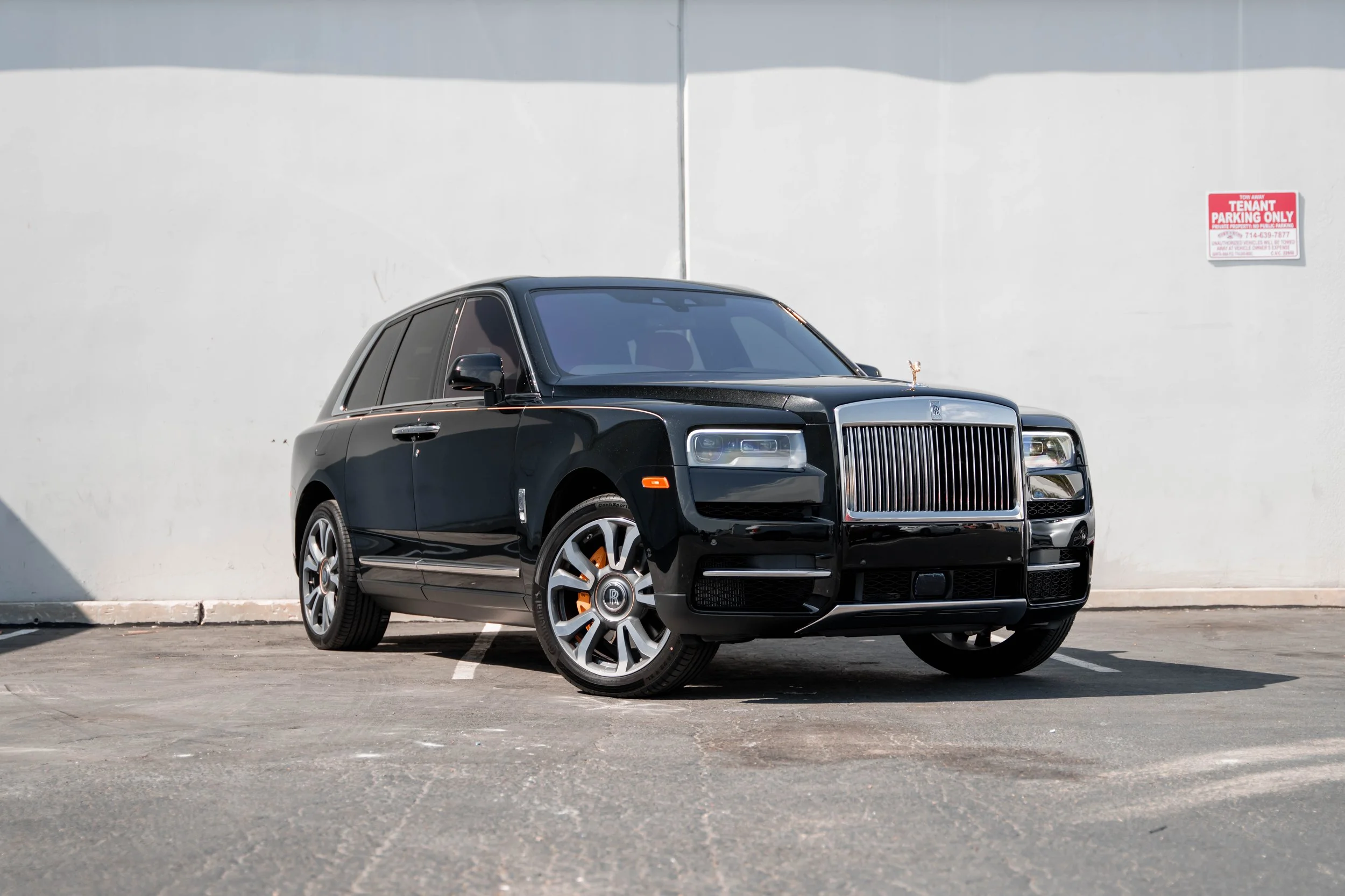 Black Rolls-Royce Cullinan with Chrome Exterior Trim — complete clean front three-quarter landscape view with bright grille and wheel faces