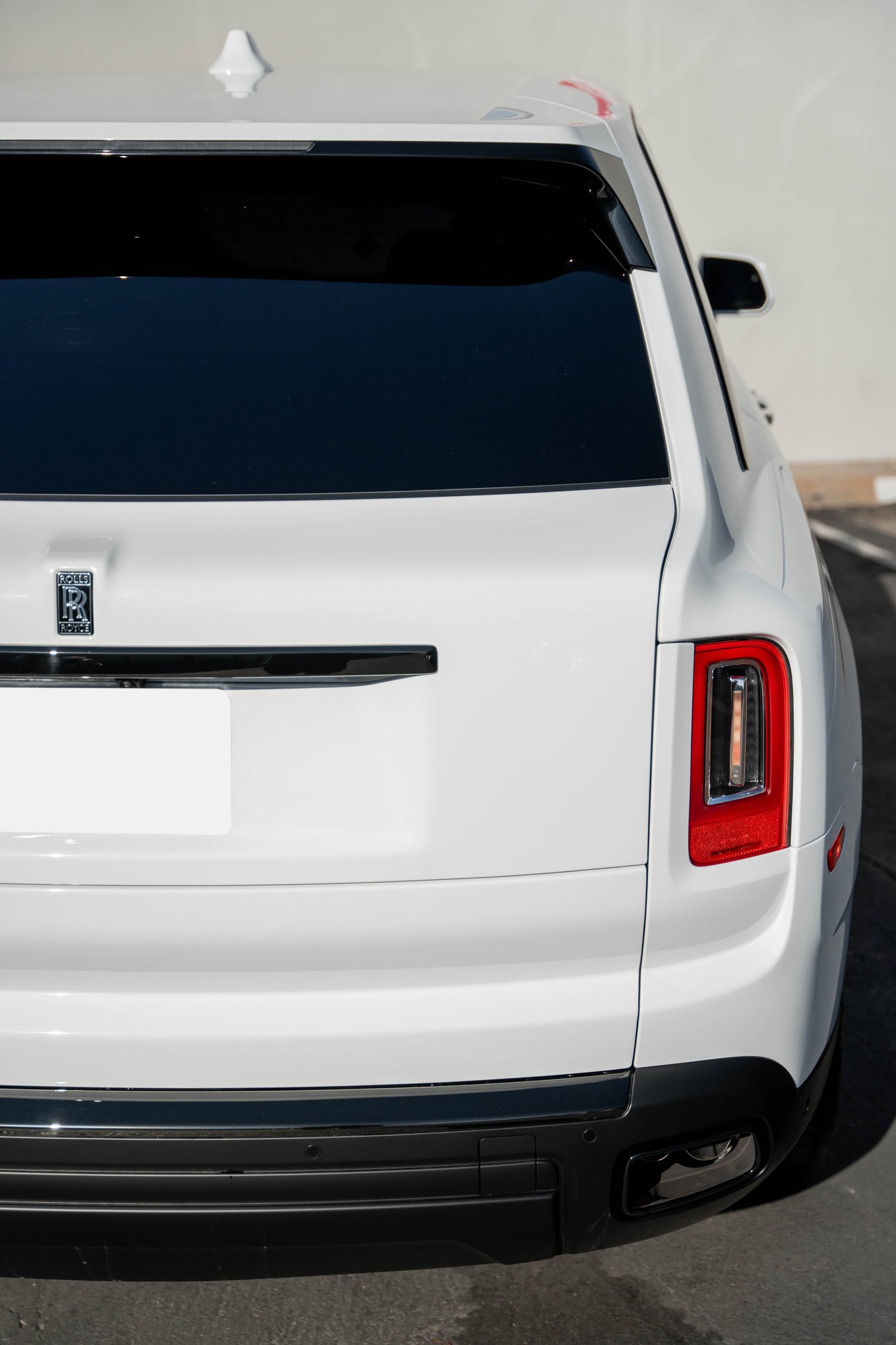 White Rolls-Royce Cullinan after Paint Protection Film (PPF), Window Tint and Ceramic Coating, rear body and taillight view