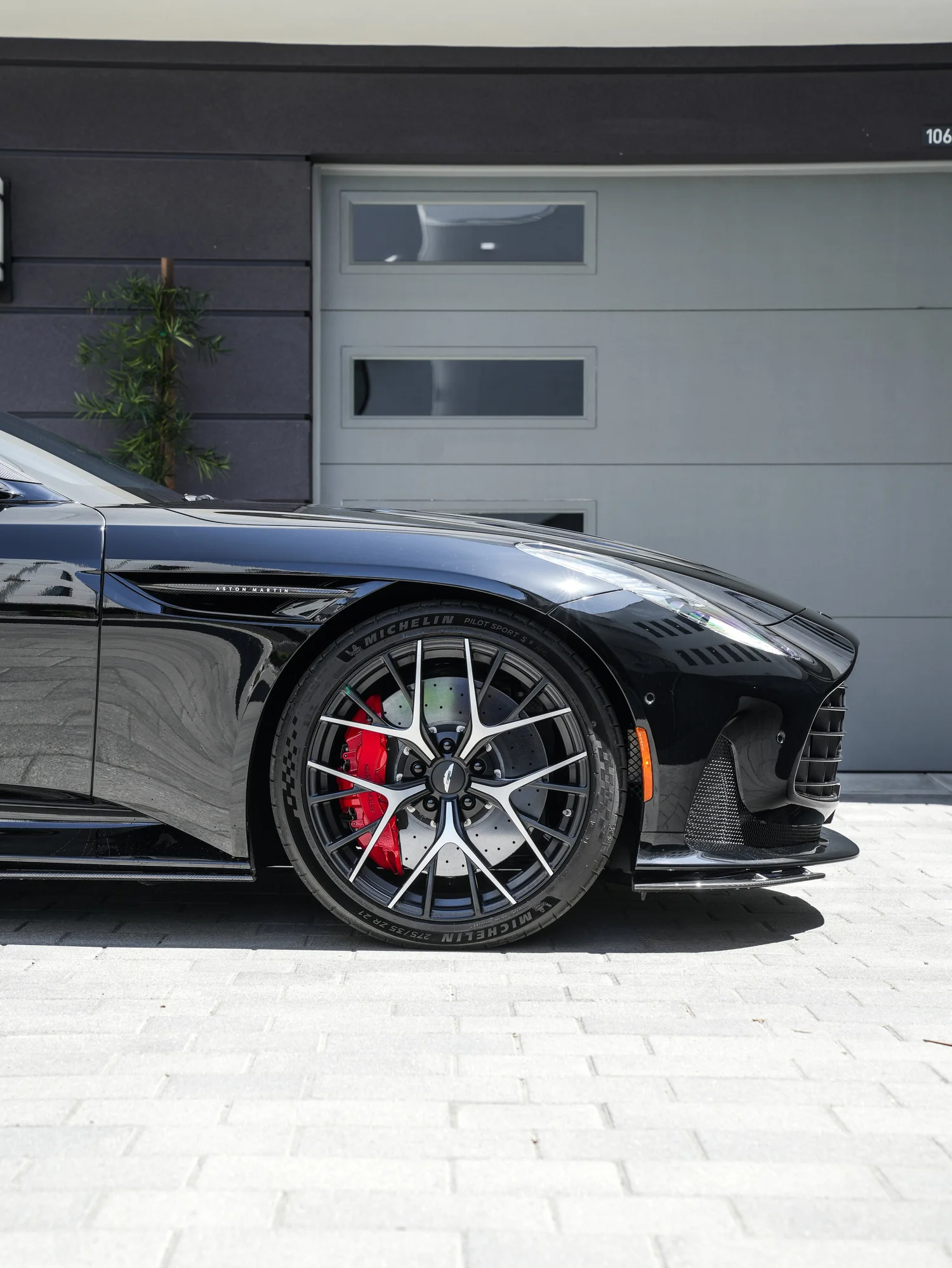 Aston Martin DB12 front wheel, red brake caliper and front quarter detail after full exterior PPF, window tint and ceramic coating