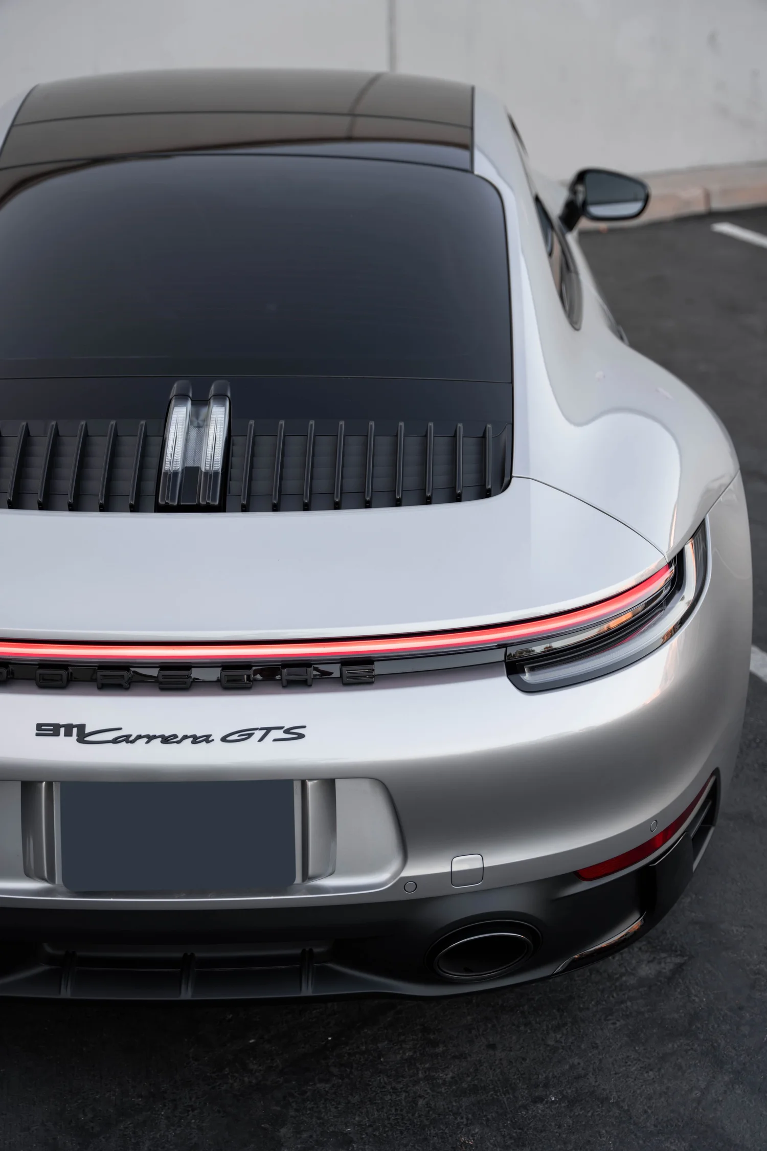 Porsche 911 Carrera GTS (992.1) after Paint Protection Film (PPF), Window Tint, Ceramic Coating and Custom Graphics, rear bumper and taillight detail
