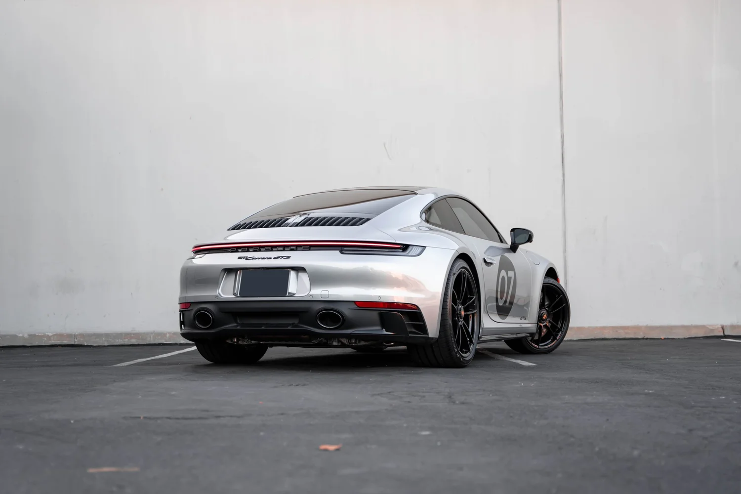 Porsche 911 Carrera GTS (992.1) after Paint Protection Film (PPF), Window Tint, Ceramic Coating and Custom Graphics, rear-left three-quarter view
