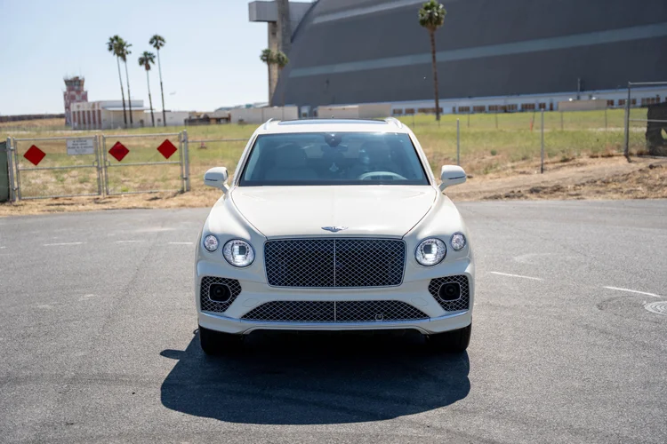Centered front view showing both mirrors, round headlamps and the grille.