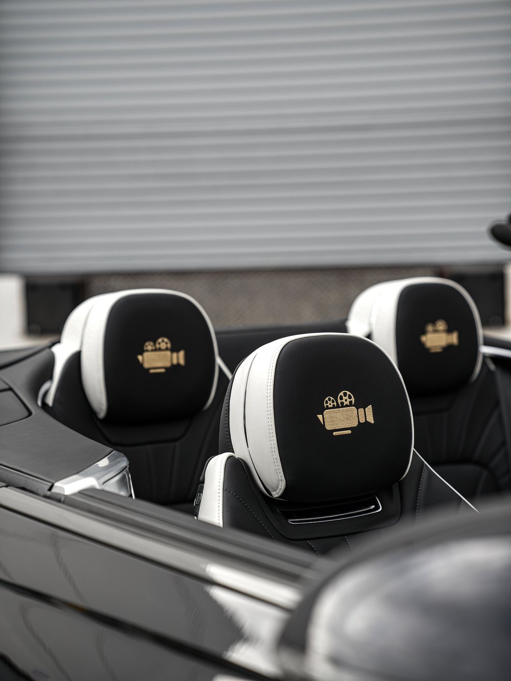 Black and white Bentley headrests with film-camera embroidery in the open Film Noir Collection cabin.