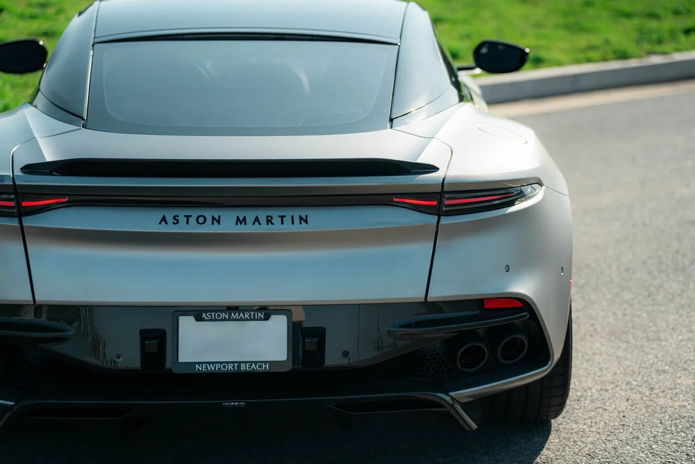 Elevated rear view of the matte-finish DBS with a dark spoiler, slim taillights and rear diffuser