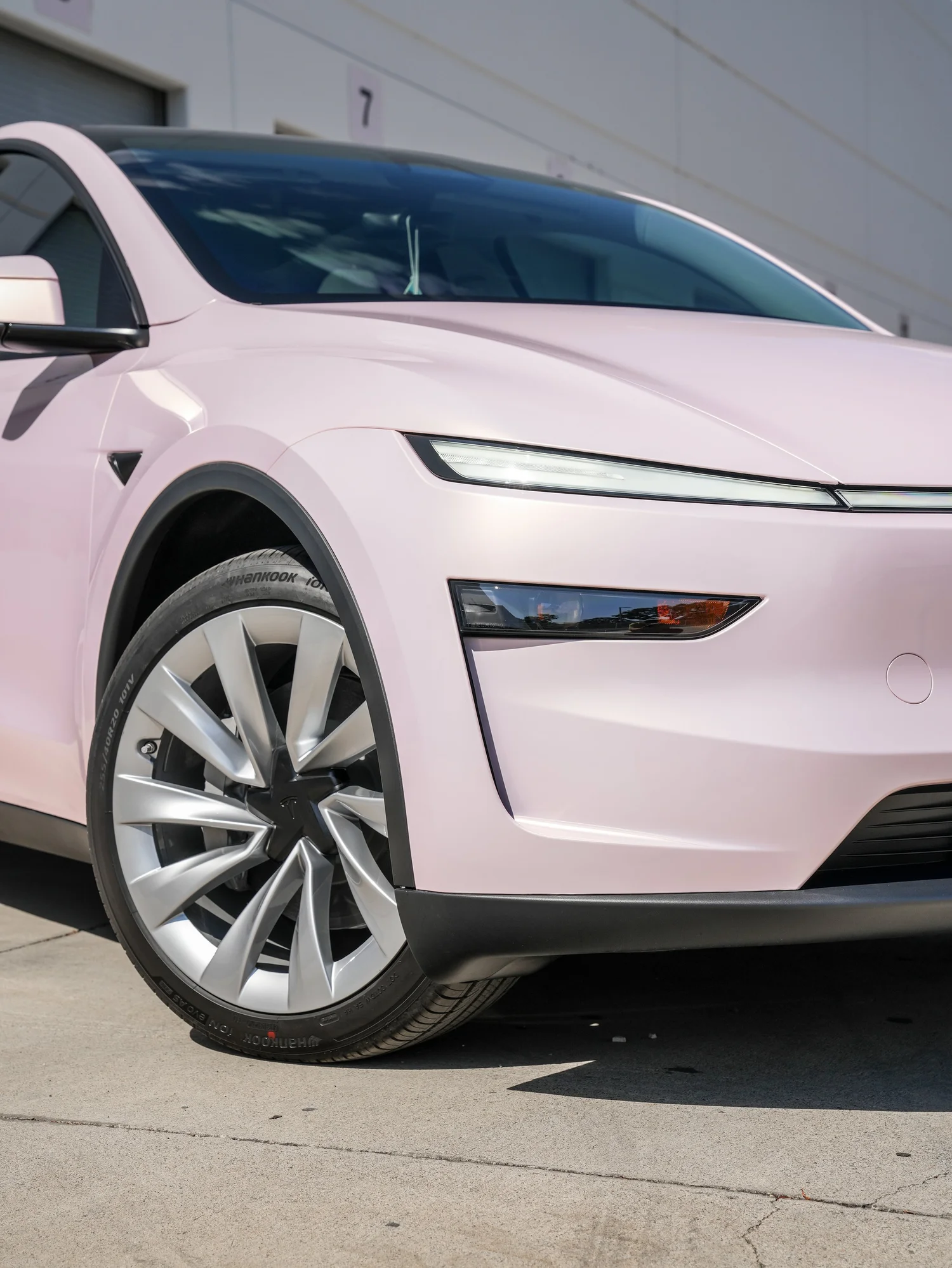 Tesla Model Y Champagne Pink after Vinyl Wrap, front wheel and body view