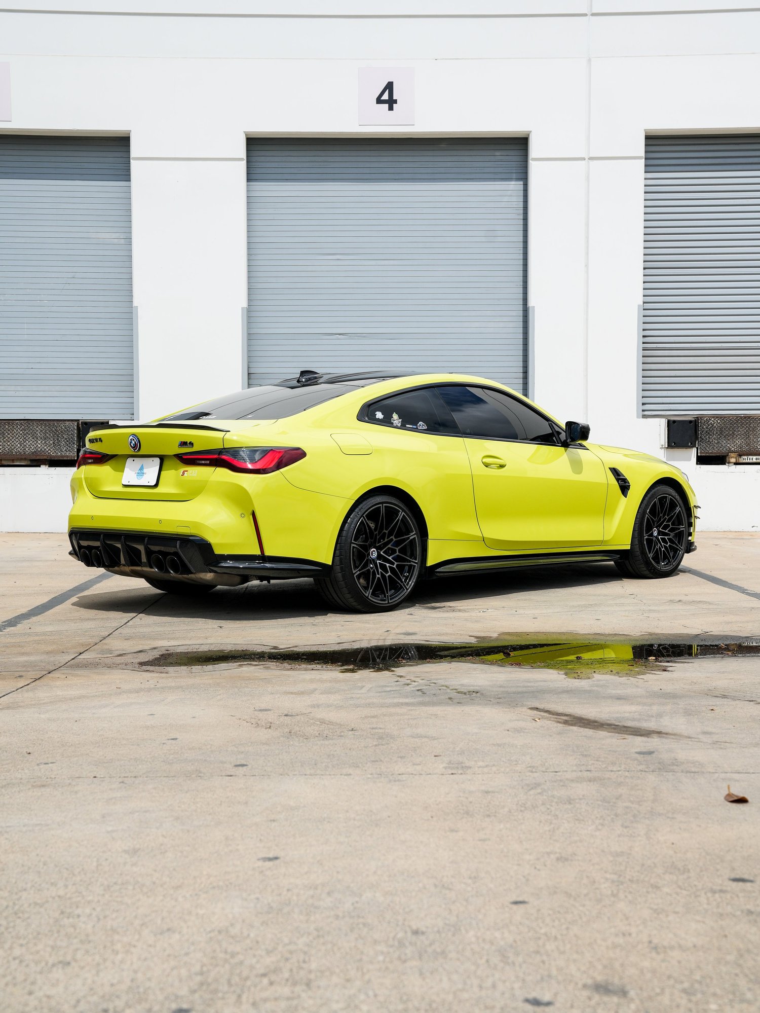 BMW M4 after Paint Protection Film (PPF), rear-left three-quarter view