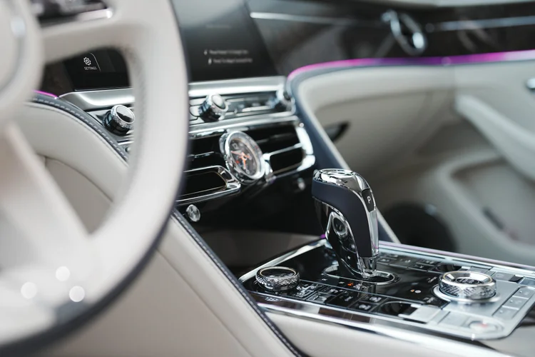 Black gear selector and bright console controls beneath the dashboard clock.