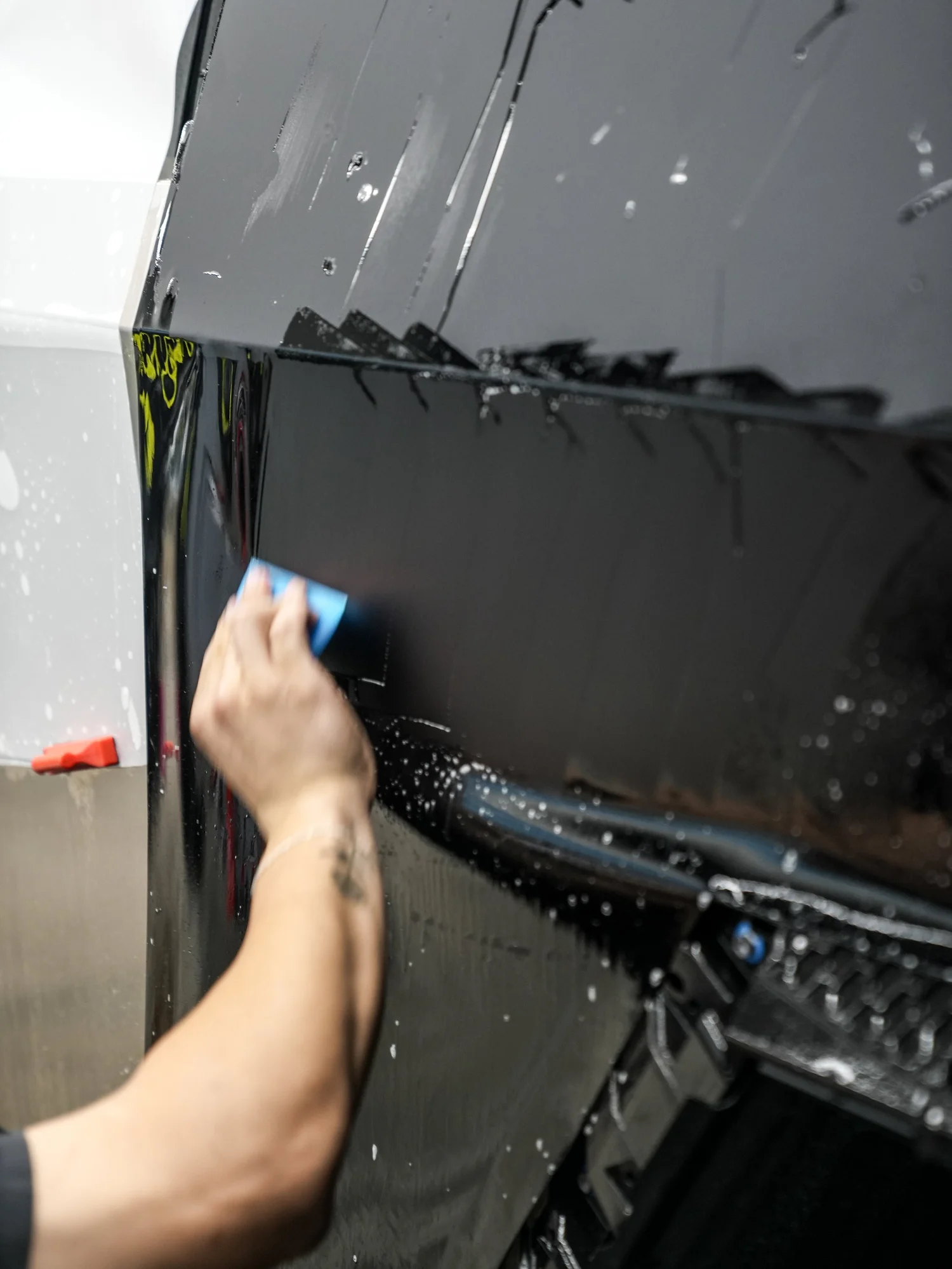 Tesla Cybertruck matte black film installation on the tailgate after PROTEK matte black PPF and window tint