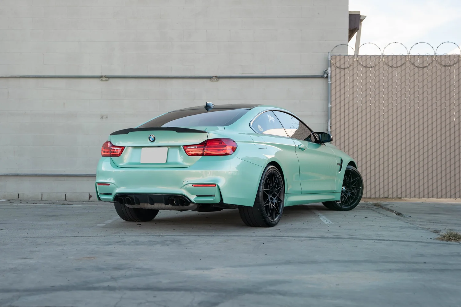 BMW M4 Mint Green after Vinyl Wrap, rear-left three-quarter view