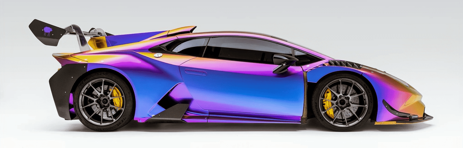 Glossy multicolor performance vehicle photographed against a bright studio background at Toyz Detail Studio.
