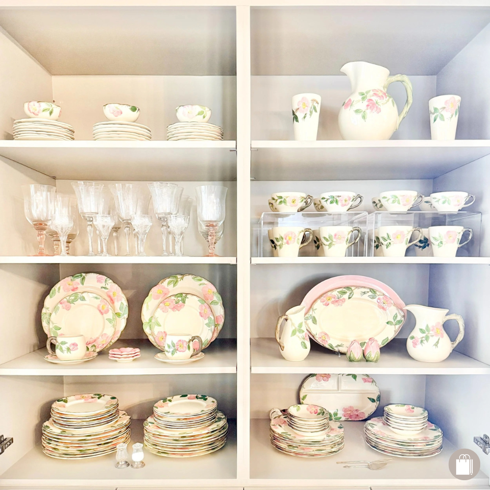 Pink and cream floral china beautifully on display using plate stands and risers