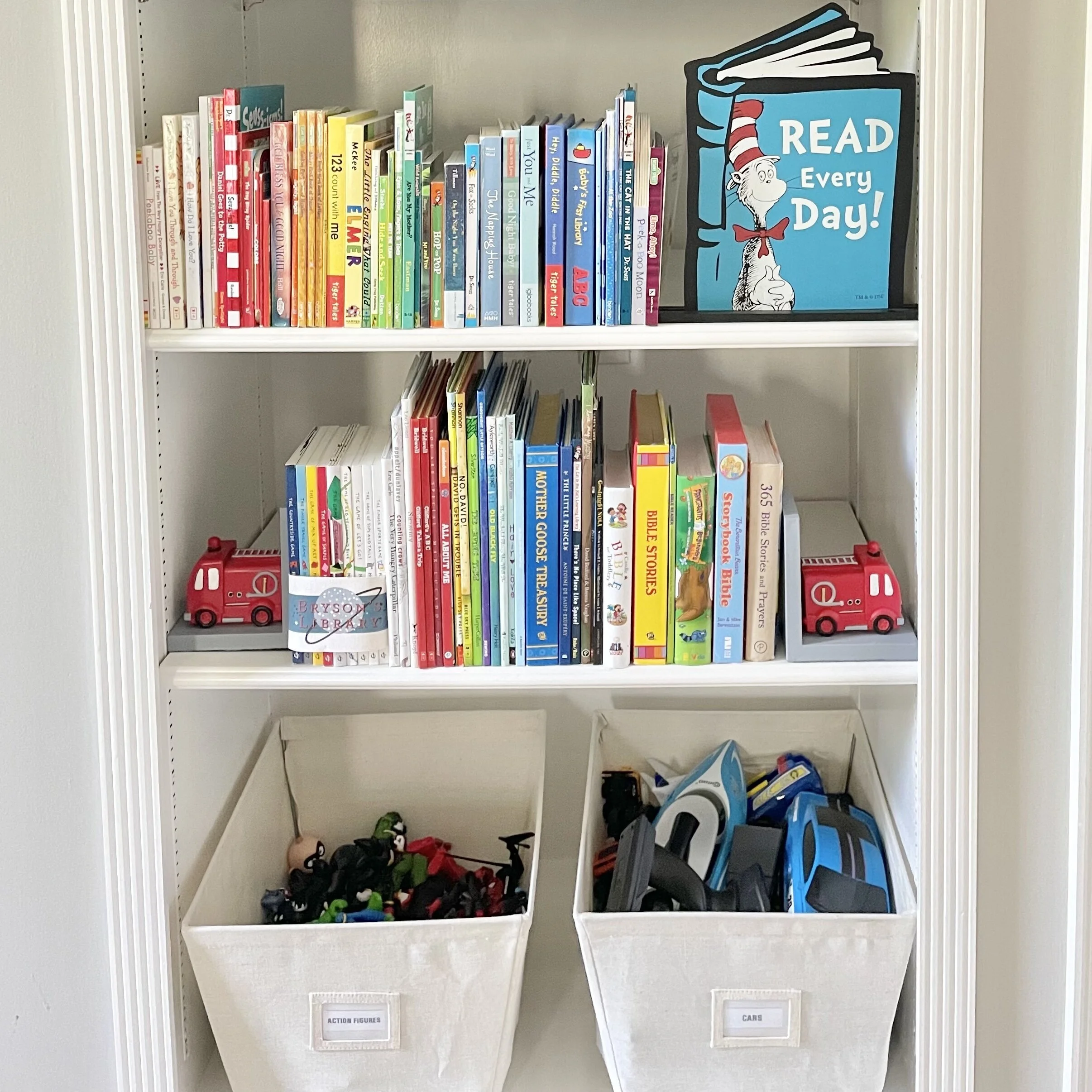 Primary color organized children's books on shelves and canvas bins of toys decluttered by Sorted Professional Organizers in New Orleans.