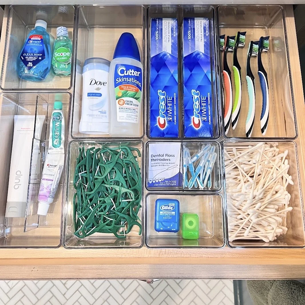 Bathroom drawer neatly organized with The Home Edit acrylic bins for functional storage by Sorted Professional Organizing.