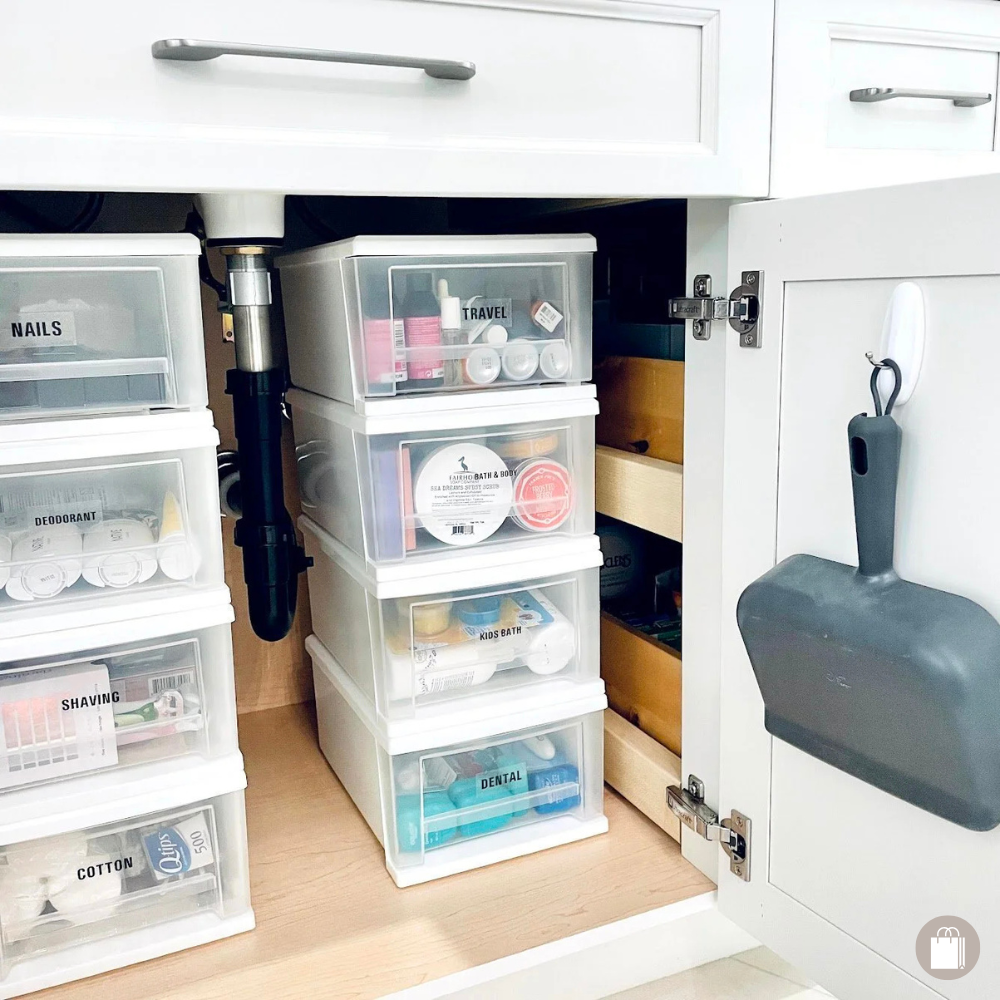 Bathroom under-sink storage organized with plastic bins and a Command hook by Sorted Professional Organizing in New Orleans.