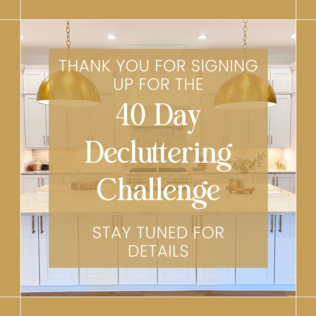 An overlayed message on a kitchen background thanking users for signing up for a 40-day decluttering challenge, with text indicating to stay tuned for details. The kitchen features white cabinets, a marble countertop, and gold pendant lights.
