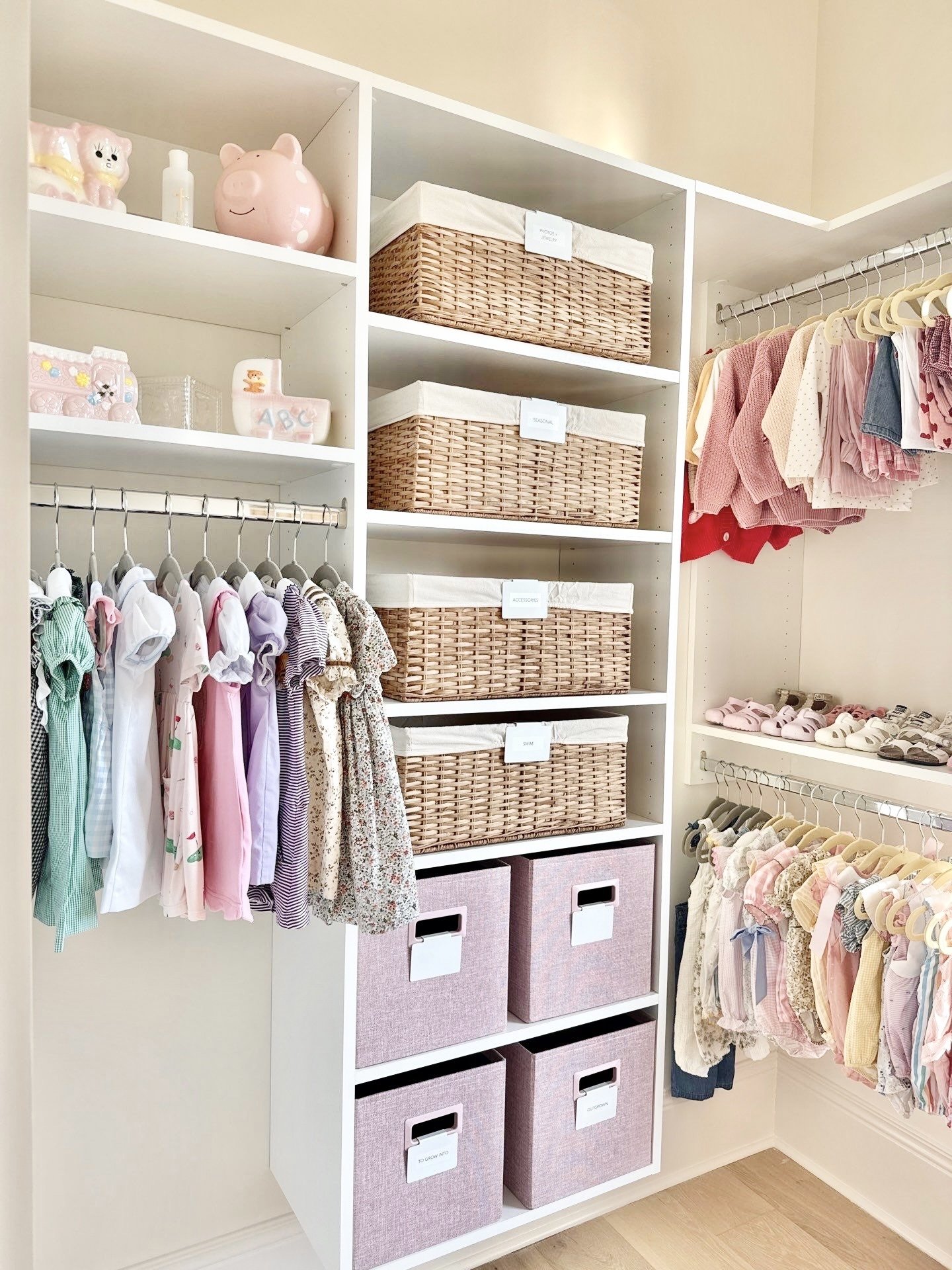 A young girl's closet with organized shelves, baskets, and hanging clothes including dresses, tops, and shoes.