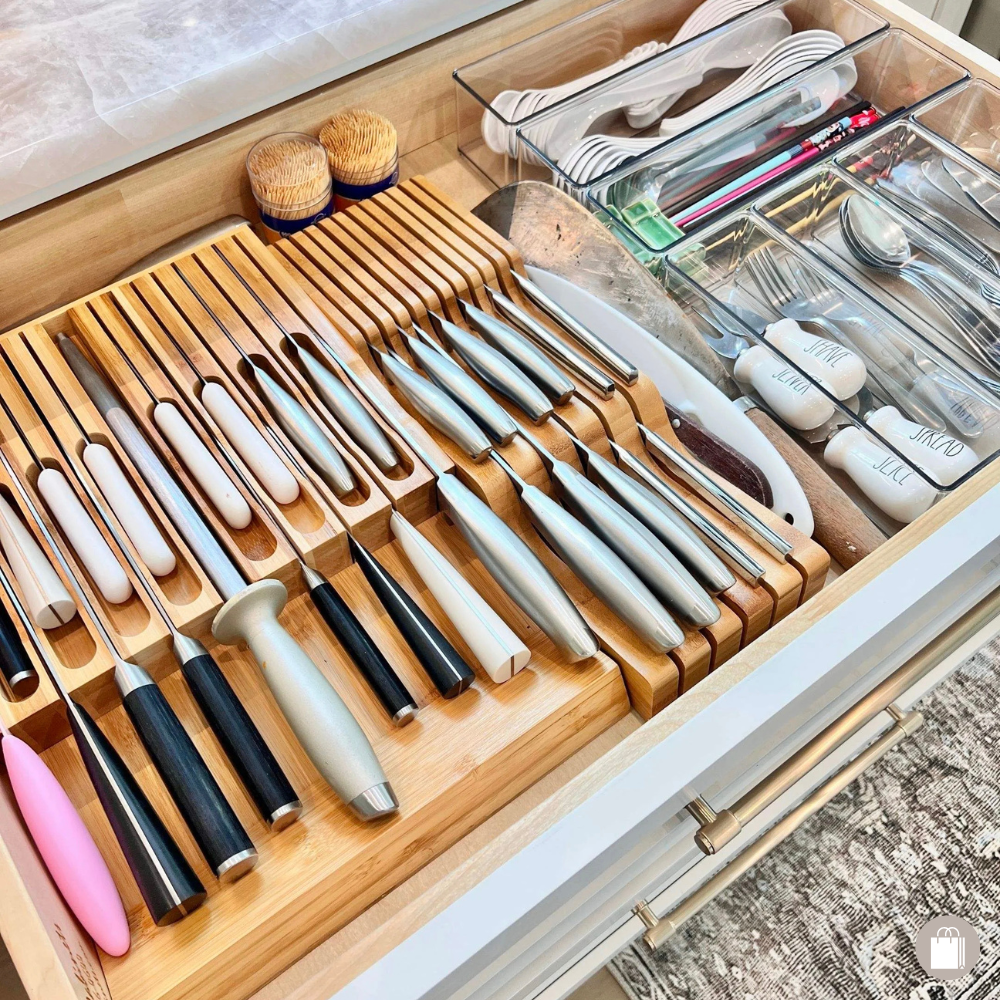 Kitchen drawer organized with knives, cooking utensils, chopsticks, and storage containers.