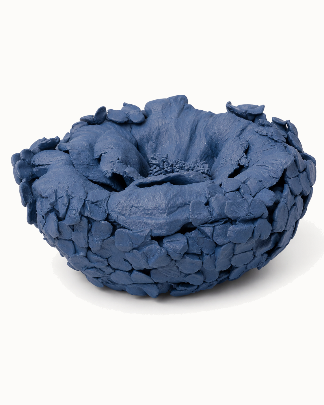A one-of-a-kind hand-built bowl layered with clay petals, in denim blue.