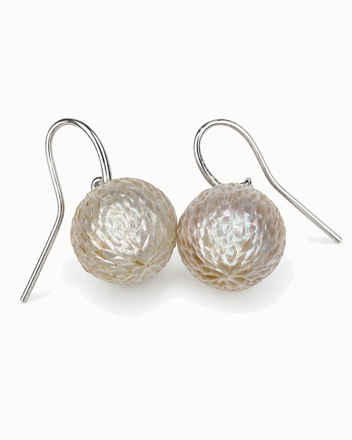 Light-catching carved freshwater pearl spheres sterling-silver hooks.