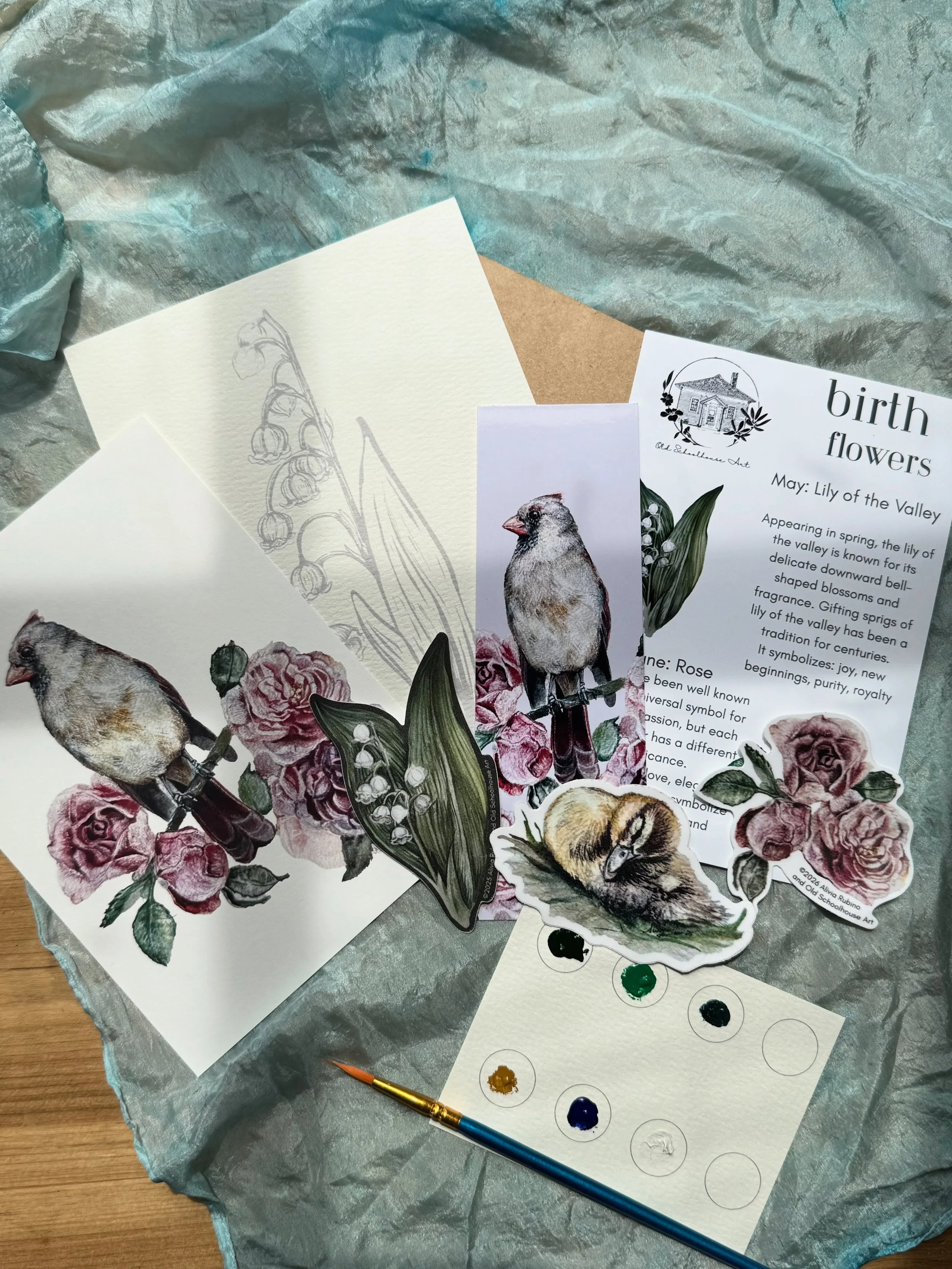 June&rsquo;s Art &amp; Nature Club Snail Mail. Lily of the valley, roses, cardinals, and ducklings.
You&rsquo;ll receive:
A flat notecard of with a message
3 stickers: the birth flowers for May and June and a duckling
Watercolor sheet with a palette 