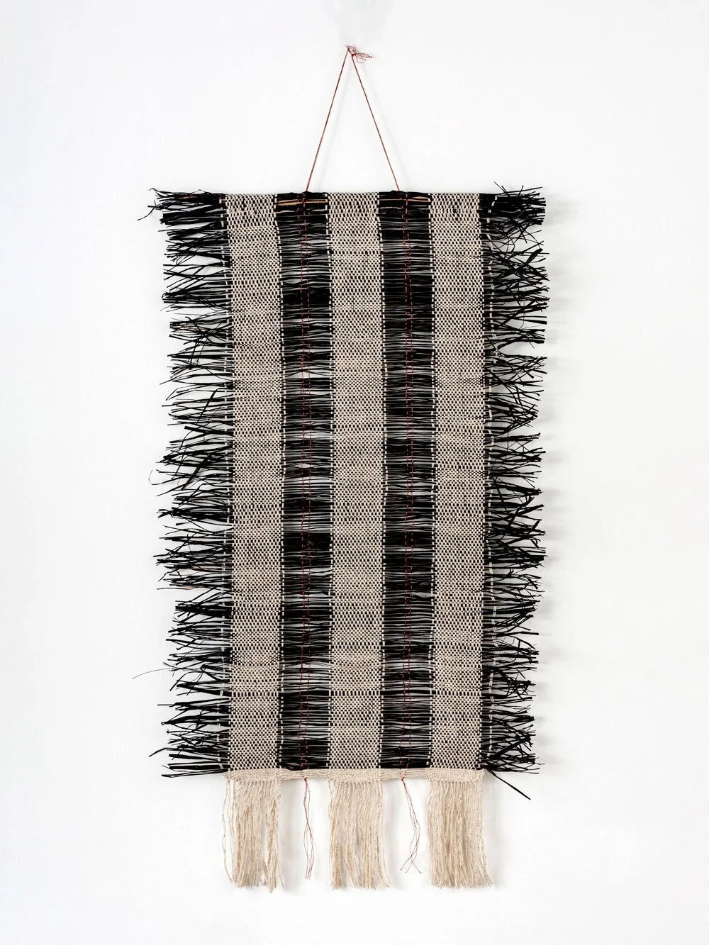 Raffia and linen black and white woven wall hanging