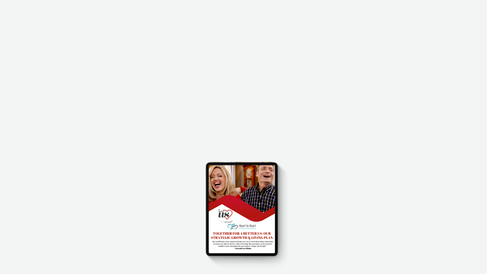 Tablet displaying a flyer with a smiling woman and man, Heart to Heart logo, and the text "Together for a better us: our strategic growth plan."